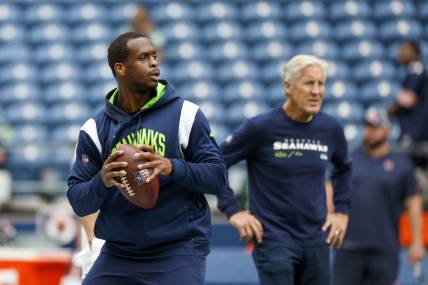 Seattle Seahawks quarterback Geno Smith and head coach Pete Carroll (background) can crash the playoffs with a win and some help from the Chicago Bears. Mandatory Credit: Joe Nicholson-USA TODAY Sports