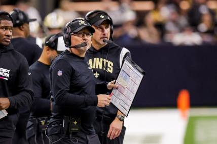 Oct 16, 2022; New Orleans, Louisiana, USA; New Orleans Saints offensive coordinator Pete Carmichael looks at the video boards against the Cincinnati Bengals during the first half at Caesars Superdome. Mandatory Credit: Stephen Lew-USA TODAY Sports