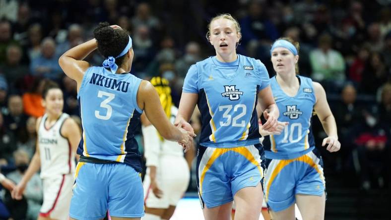 Dec 31, 2022; Storrs, Connecticut, USA; Marquette Golden Eagles forward Liza Karlen (32) and guard Rose Nkumu (3) react after a play against the UConn Huskies in the first half at Harry A. Gampel Pavilion. Mandatory Credit: David Butler II-USA TODAY Sports