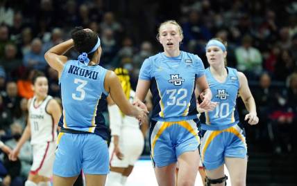 Dec 31, 2022; Storrs, Connecticut, USA; Marquette Golden Eagles forward Liza Karlen (32) and guard Rose Nkumu (3) react after a play against the UConn Huskies in the first half at Harry A. Gampel Pavilion. Mandatory Credit: David Butler II-USA TODAY Sports