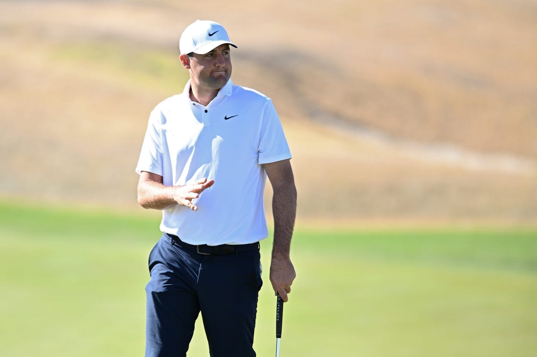 Jan 21, 2023; La Quinta, California, USA; Scottie Scheffler acknowledges the crowd after a putt on the third green during the third round of The American Express golf tournament at Pete Dye Stadium Course. Mandatory Credit: Orlando Ramirez-USA TODAY Sports