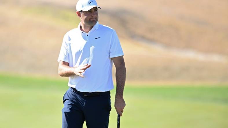 Jan 21, 2023; La Quinta, California, USA; Scottie Scheffler acknowledges the crowd after a putt on the third green during the third round of The American Express golf tournament at Pete Dye Stadium Course. Mandatory Credit: Orlando Ramirez-USA TODAY Sports