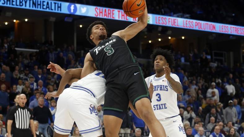 Feb 4, 2023; Memphis, Tennessee, USA; Tulane Green Wave forward Collin Holloway (5) collects a rebound as he is pulled to the ground by Memphis Tigers guard Elijah McCadden (0) during the second half at FedExForum. Mandatory Credit: Petre Thomas-USA TODAY Sports