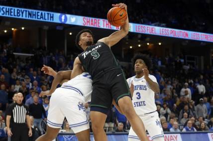 Feb 4, 2023; Memphis, Tennessee, USA; Tulane Green Wave forward Collin Holloway (5) collects a rebound as he is pulled to the ground by Memphis Tigers guard Elijah McCadden (0) during the second half at FedExForum. Mandatory Credit: Petre Thomas-USA TODAY Sports