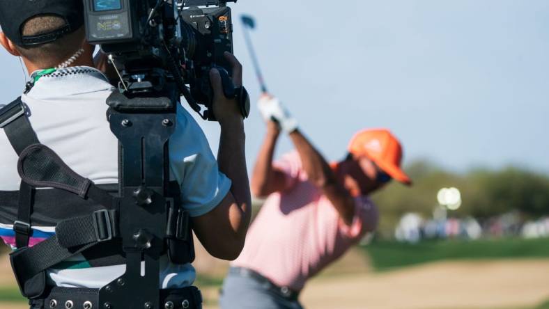 Feb 12, 2023; Scottsdale, Arizona,USA; A general view as the documentary team from Netflix Full Swing works with Rickie Fowler on the range prior to the start of the final round of the WM Phoenix Open golf tournament. Mandatory Credit: Allan Henry-USA TODAY Sports