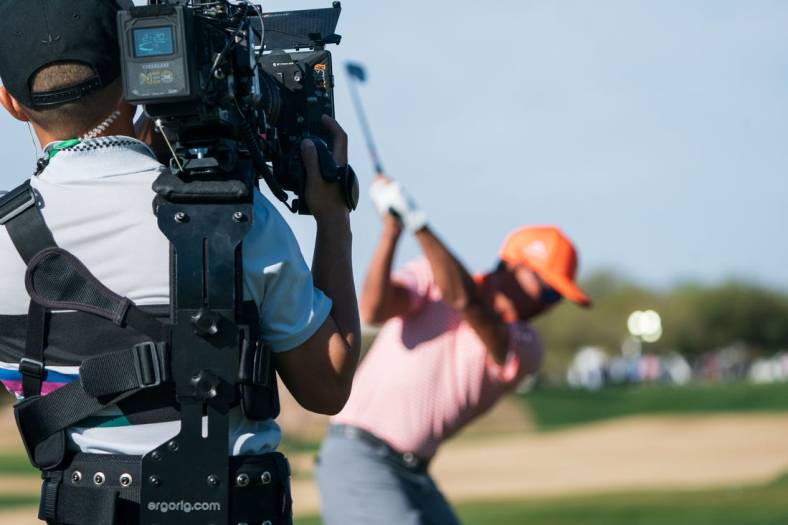 Feb 12, 2023; Scottsdale, Arizona,USA; A general view as the documentary team from Netflix Full Swing works with Rickie Fowler on the range prior to the start of the final round of the WM Phoenix Open golf tournament. Mandatory Credit: Allan Henry-USA TODAY Sports