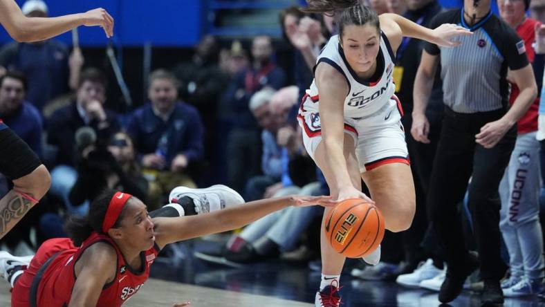 Feb 21, 2023; Hartford, Connecticut, USA; St. John's Red Storm forward Danielle Patterson (3) and Connecticut Huskies guard Caroline Ducharme (33) reach for a loose ball during the second half at XL Center. Mandatory Credit: Gregory Fisher-USA TODAY Sports