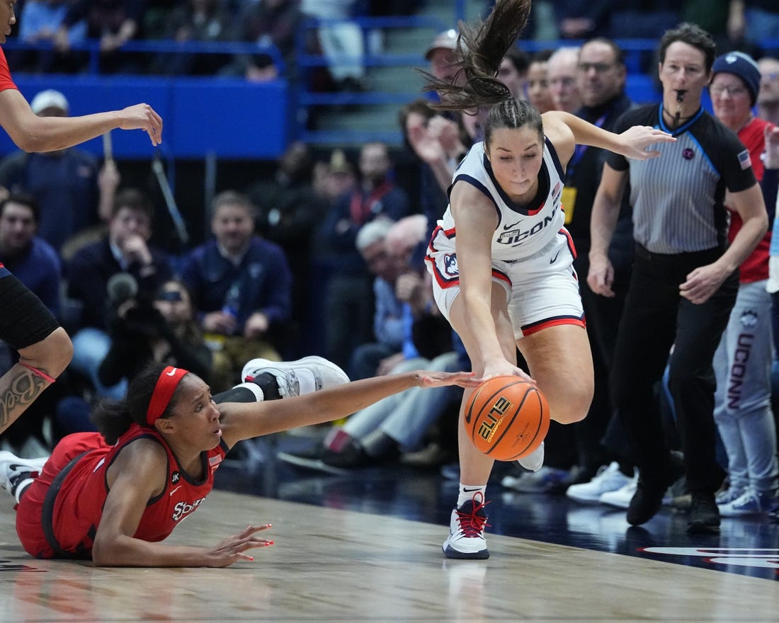 Feb 21, 2023; Hartford, Connecticut, USA; St. John's Red Storm forward Danielle Patterson (3) and Connecticut Huskies guard Caroline Ducharme (33) reach for a loose ball during the second half at XL Center. Mandatory Credit: Gregory Fisher-USA TODAY Sports