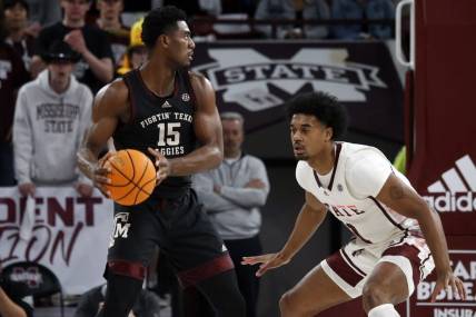 Feb 25, 2023; Starkville, Mississippi, USA; Aggies forward Henry Coleman III (15) handles the ball as Mississippi State Bulldogs forward Tolu Smith (1) defends during the first half at Humphrey Coliseum. Mandatory Credit: Petre Thomas-USA TODAY Sports