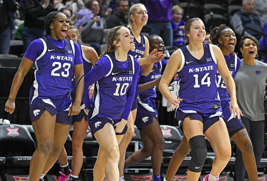 Mar 10, 2023; Kansas City, MO, USA;  Kansas State Wildcats guard Mimi Gatewood (23), Mikayla Parks (10) and Rebekah Dallinger (14) reacts after a Wildcat score during the first half against the Texas Longhorns at Municipal Auditorium. Mandatory Credit: Peter Aiken-USA TODAY Sports