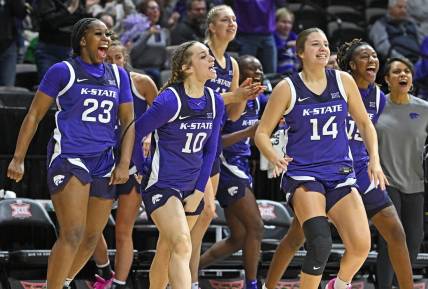 Mar 10, 2023; Kansas City, MO, USA;  Kansas State Wildcats guard Mimi Gatewood (23), Mikayla Parks (10) and Rebekah Dallinger (14) reacts after a Wildcat score during the first half against the Texas Longhorns at Municipal Auditorium. Mandatory Credit: Peter Aiken-USA TODAY Sports