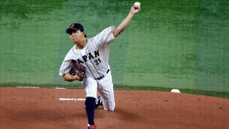 Mar 21, 2023; Miami, Florida, USA; Japan starting pitcher Shota Imanaga (21) pitches against the USA in the first inning at LoanDepot Park. Mandatory Credit: Rhona Wise-USA TODAY Sports