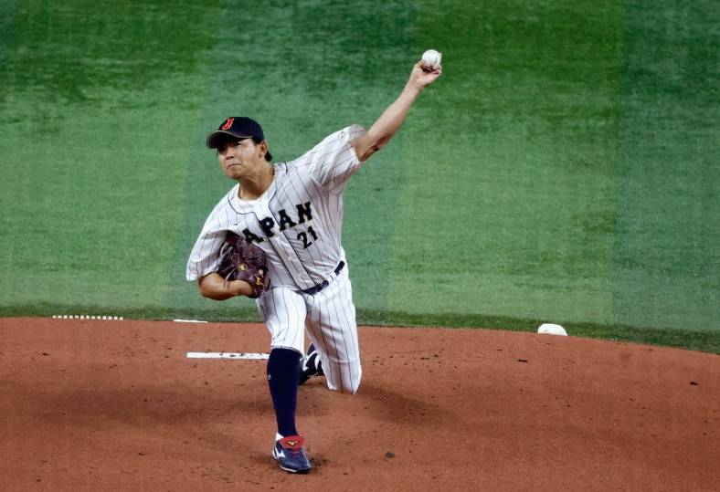 Mar 21, 2023; Miami, Florida, USA; Japan starting pitcher Shota Imanaga (21) pitches against the USA in the first inning at LoanDepot Park. Mandatory Credit: Rhona Wise-USA TODAY Sports