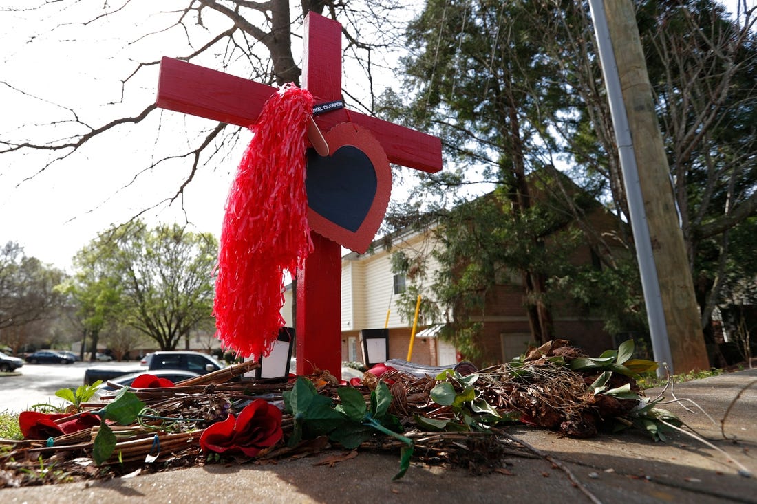 A memorial at the crash site were UGA football player Devin Willock and UGA staffer Chandler LeCroy died in a car crash on Barnett Shoals Road in Athens.