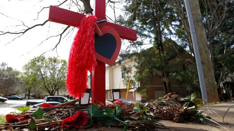 A memorial at the crash site were UGA football player Devin Willock and UGA staffer Chandler LeCroy died in a car crash on Barnett Shoals Road in Athens.