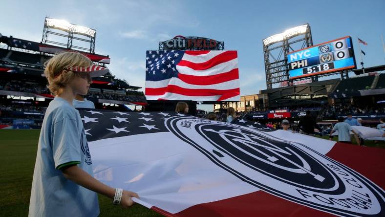 May 27, 2023; Flushing, New York, USA; A young fan holds a banner during the national anthem before a match between New York City FC and the Philadelphia Union at Citi Field. Mandatory Credit: Brad Penner-USA TODAY Sports