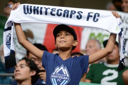 Jul 21, 2023; Vancouver, British Columbia, CAN; A young Vancouver Whitecaps fan is seen holding a scarf during the second half between the Vancouver Whitecaps and Club Leon at BC Place. Mandatory Credit: Anne-Marie Sorvin-USA TODAY Sports
