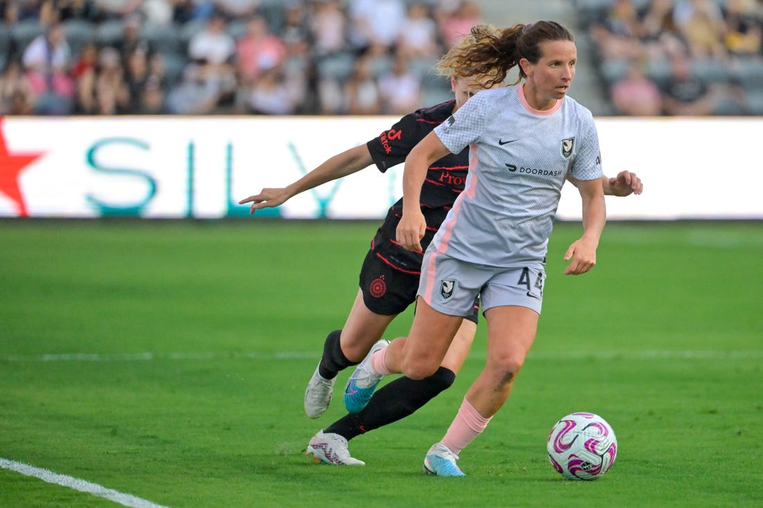 Jul 29, 2023; Los Angeles, CA, USA;  Angel City FC defender Elizabeth Eddy (44) dribbles the ball against Portland Thorns FC defender Natalia Kuikka (14) in the first half at BMO Stadium. Mandatory Credit: Jayne Kamin-Oncea-USA TODAY Sports