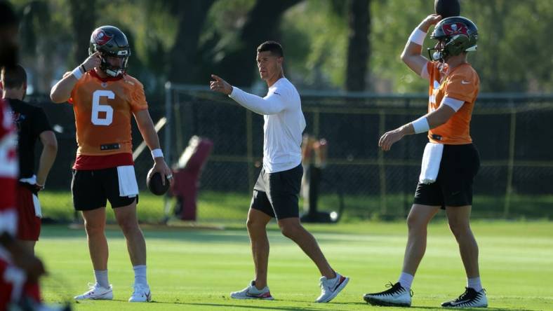 Jul 30, 2023; Tampa, FL, USA; Tampa Bay Buccaneers offensive coordinator Dave Canales talks with quarterback Baker Mayfield (6) and quarterback Kyle Trask (2) during training camp at AdventHealth Training Center. Mandatory Credit: Kim Klement-USA TODAY Sports