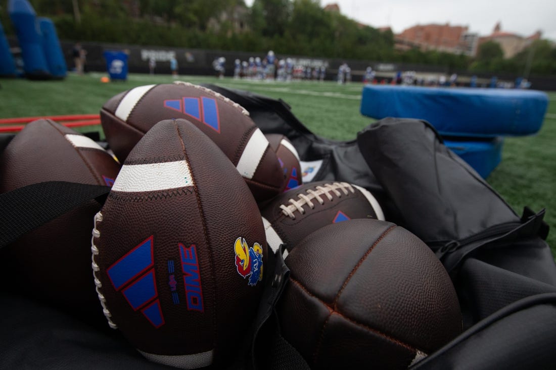 Kansas practice footballs are seen in an equipment bag at Monday's practice.