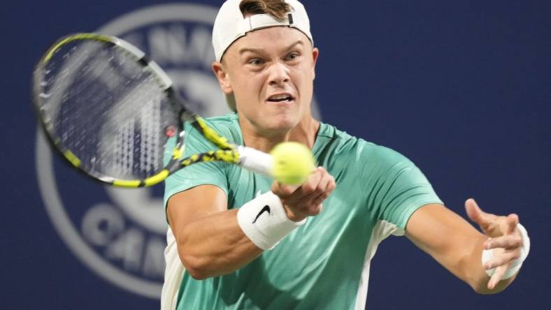 Aug 9, 2023; Toronto, Ontario, Canada; Holger Rune (DEN) hits a ball to Marcos Giron (not pictured) at Sobeys Stadium. Mandatory Credit: John E. Sokolowski-USA TODAY Sports