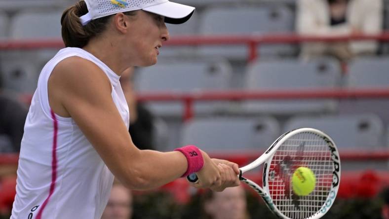 Aug 11, 2023; Montreal, Quebec, Canada; Iga Swiatek (POL) hits a backhand against Danielle Collins (USA) (not pictured) during quarterfinal play at IGA Stadium. Mandatory Credit: Eric Bolte-USA TODAY Sports