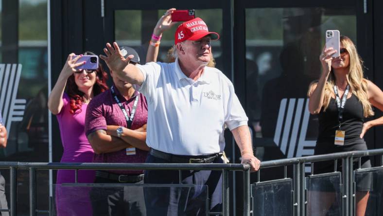 Aug 13, 2023; Bedminster, New Jersey, USA; Former President Donald Trump waves to the fans during the final round of the LIV Golf Bedminster golf tournament at Trump National Bedminster. Mandatory Credit: Vincent Carchietta-USA TODAY Sports