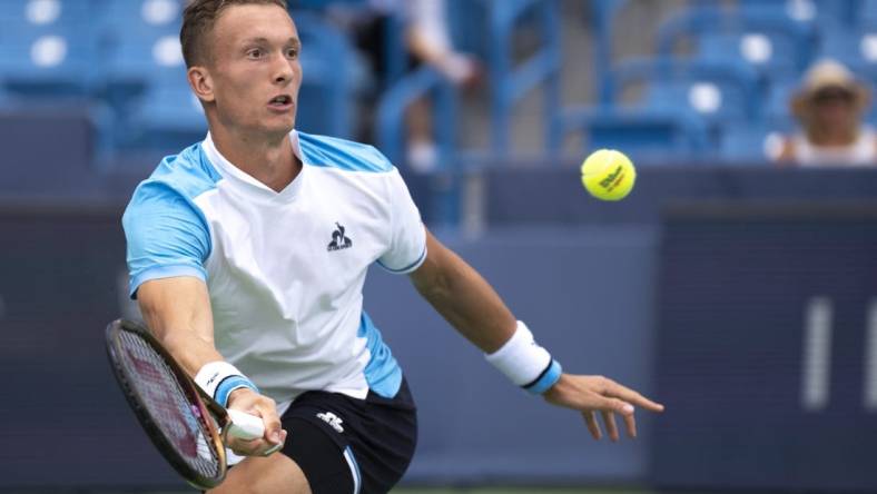 Aug 15, 2023; Mason, OH, USA; Jiri Lehecka, of Czech Republic, hits a return to Taylor Fritz, of the United States, during the Western & Southern Open at Lindner Family Tennis Center. Mandatory Credit: Albert Cesare-USA TODAY Sports