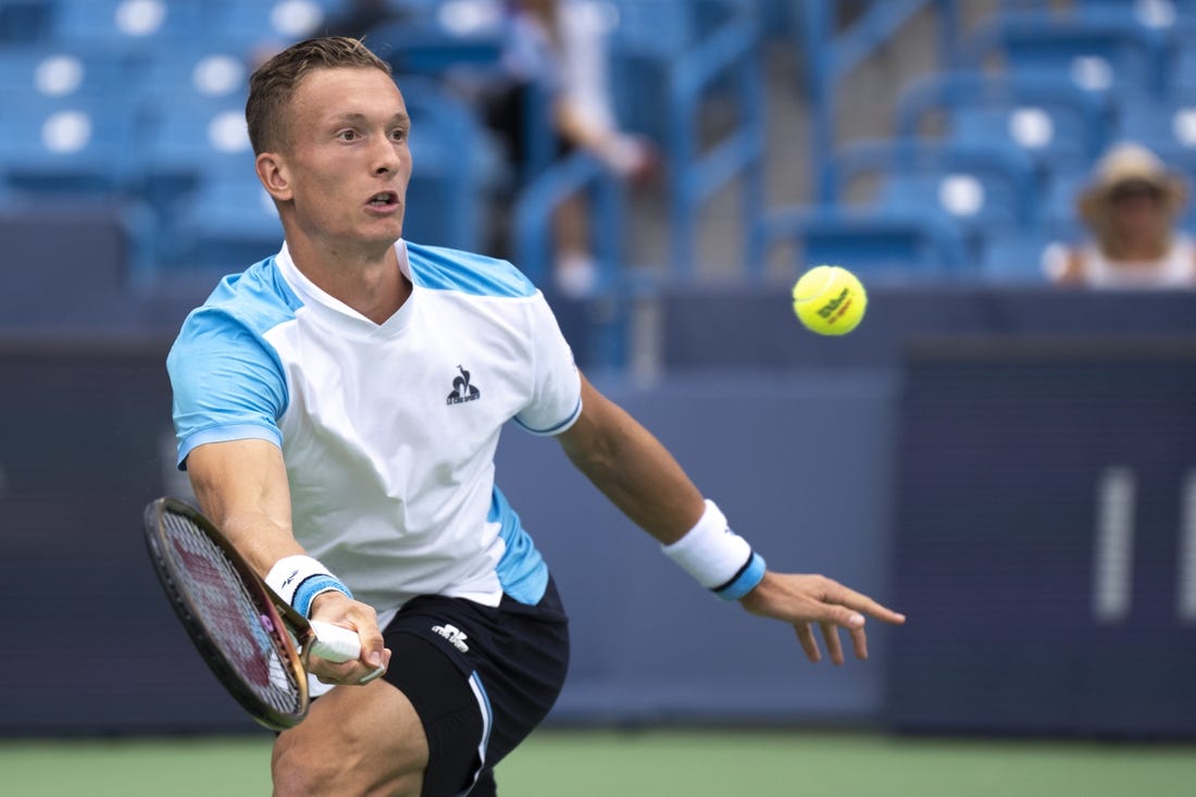 Aug 15, 2023; Mason, OH, USA; Jiri Lehecka, of Czech Republic, hits a return to Taylor Fritz, of the United States, during the Western & Southern Open at Lindner Family Tennis Center. Mandatory Credit: Albert Cesare-USA TODAY Sports