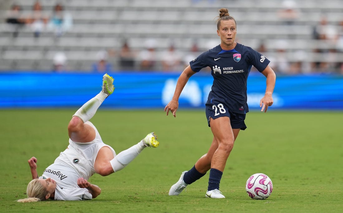 Aug 19, 2023; San Diego, California, USA; San Diego Wave FC midfielder Meggie Dougherty Howard (28) dribbles past NJ/NY Gotham FC midfielder Jenna Nighswonger (32) during the first half at Snapdragon Stadium. Mandatory Credit: Ray Acevedo-USA TODAY Sports