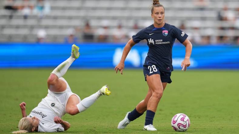 Aug 19, 2023; San Diego, California, USA; San Diego Wave FC midfielder Meggie Dougherty Howard (28) dribbles past NJ/NY Gotham FC midfielder Jenna Nighswonger (32) during the first half at Snapdragon Stadium. Mandatory Credit: Ray Acevedo-USA TODAY Sports