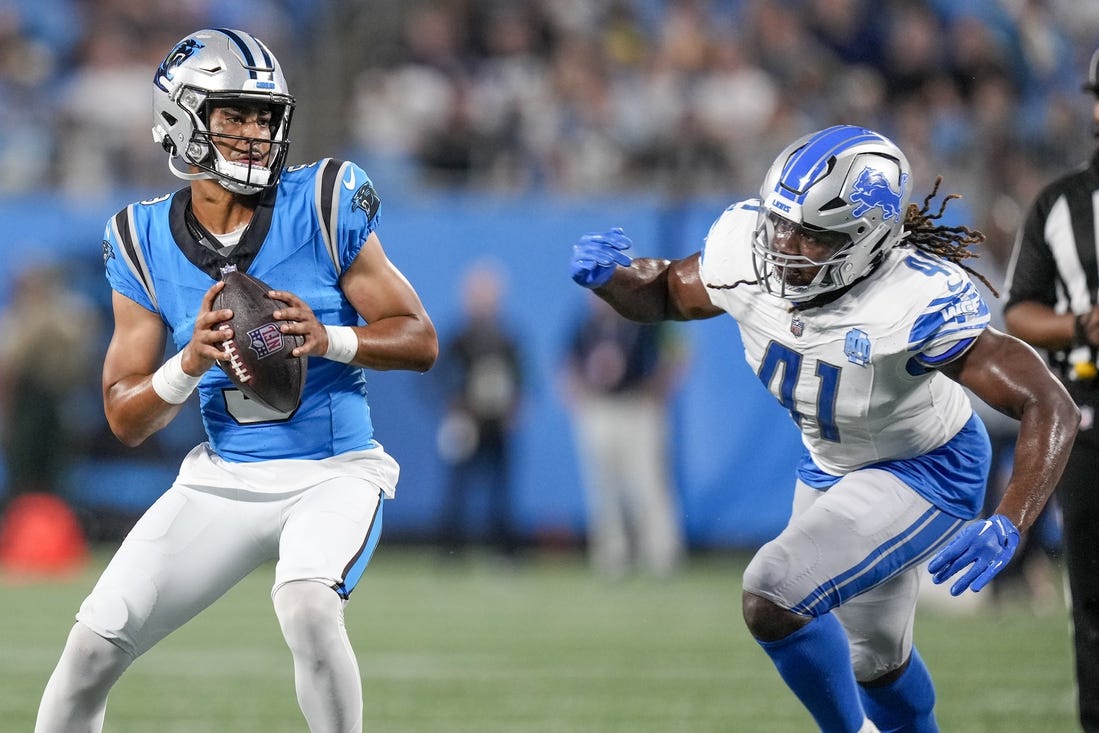 Aug 25, 2023; Charlotte, North Carolina, USA; Carolina Panthers quarterback Bryce Young (9) drops back under pressure from Detroit Lions linebacker James Houston (41) during the first quarter at Bank of America Stadium. Mandatory Credit: Jim Dedmon-USA TODAY Sports