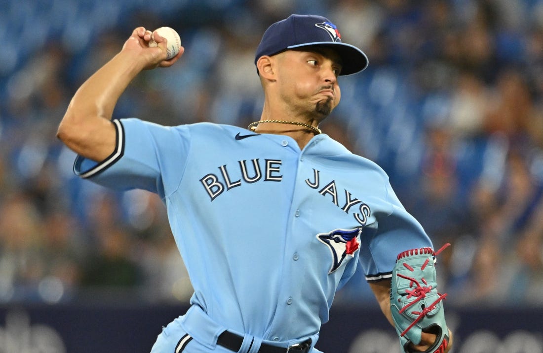 Aug 28, 2023; Toronto, Ontario, CAN;  Toronto Blue Jays relief pitcher Jordan Hicks (12) delivers a pitch against the Washington Nationals in the ninth inning at Rogers Centre. Mandatory Credit: Dan Hamilton-USA TODAY Sports