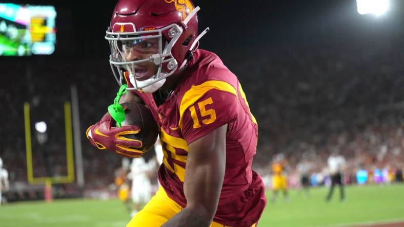 Sep 9, 2023; Los Angeles, California, USA; Southern California Trojans wide receiver Dorian Singer (15) catches a 19-yard touchdown pass against the Stanford Cardinal in the first half at United Airlines Field at Los Angeles Memorial Coliseum. Mandatory Credit: Kirby Lee-USA TODAY Sports