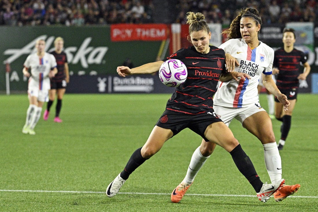 Sep 16, 2023; Portland, Oregon, USA; Portland Thorns FC defender Natalia Kuikka (14) moves the ball against OL Reign midfielder Angelina (6) at Providence Park. Mandatory Credit: Troy Wayrynen-USA TODAY Sports