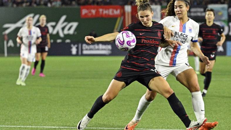 Sep 16, 2023; Portland, Oregon, USA; Portland Thorns FC defender Natalia Kuikka (14) moves the ball against OL Reign midfielder Angelina (6) at Providence Park. Mandatory Credit: Troy Wayrynen-USA TODAY Sports