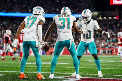 Sep 17, 2023; Foxborough, Massachusetts, USA; Miami Dolphins running back Raheem Mostert (31) celebrates with wide receiver Tyreek Hill (10) and wide receiver Jaylen Waddle (17) after scoring against the New England Patriots in the second quarter at Gillette Stadium. Mandatory Credit: David Butler II-USA TODAY Sports
