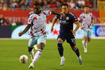 Sep 23, 2023; Chicago, Illinois, USA; Chicago Fire defender Carlos Teran (4) steals the ball from New England Revolution forward Bobby Wood (17) from during the second half at Soldier Field. Mandatory Credit: Mike Dinovo-USA TODAY Sports