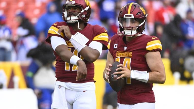 Sep 24, 2023; Landover, Maryland, USA; Washington Commanders quarterback Sam Howell (14) and quarterback Jacoby Brissett (12) on the field before the game against the Buffalo Bills at FedExField. Mandatory Credit: Brad Mills-USA TODAY Sports