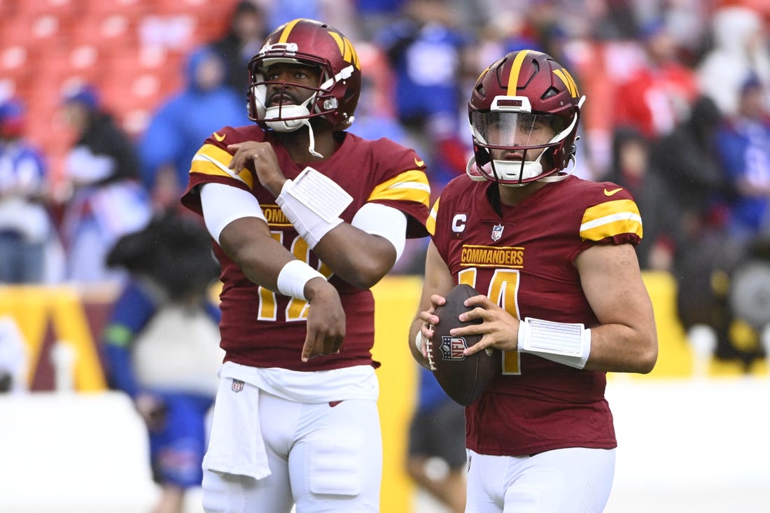 Sep 24, 2023; Landover, Maryland, USA; Washington Commanders quarterback Sam Howell (14) and quarterback Jacoby Brissett (12) on the field before the game against the Buffalo Bills at FedExField. Mandatory Credit: Brad Mills-USA TODAY Sports