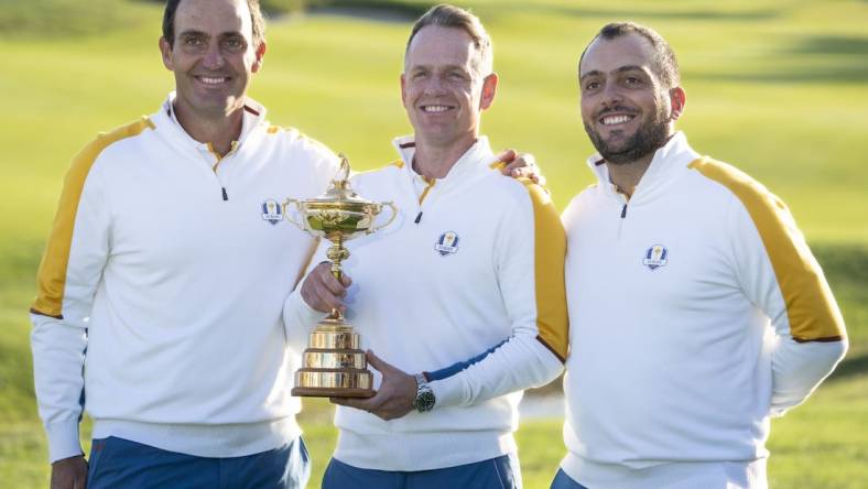 September 26, 2023; Rome, ITALY; (L-R) Team Europe vice-captain Edoardo Molinari, captain Luke Donald, and vice-captain Francesco Molinari pose for a photo with The Ryder Cup trophy during a practice round of the Ryder Cup golf competition at Marco Simone Golf and Country Club. Mandatory Credit: Kyle Terada-USA TODAY Sports