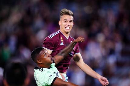 Sep 30, 2023; Commerce City, Colorado, USA; Austin FC midfielder Jhojan Valencia (5) and Colorado Rapids midfielder Cole Bassett (23) during the second half at Dick's Sporting Goods Park. Mandatory Credit: Ron Chenoy-USA TODAY Sports