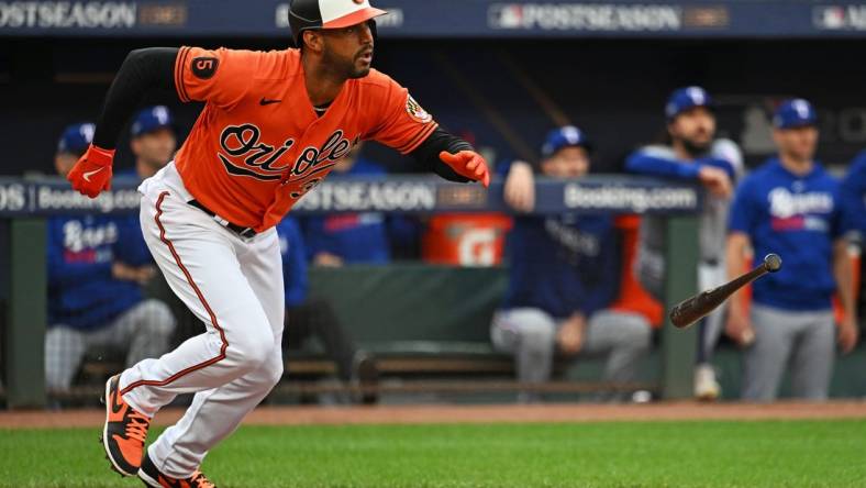 Oct 8, 2023; Baltimore, Maryland, USA; Baltimore Orioles center fielder Aaron Hicks (34) hits a two run RBI during the first inning against the Texas Rangers during game two of the ALDS for the 2023 MLB playoffs at Oriole Park at Camden Yards. Mandatory Credit: Tommy Gilligan-USA TODAY Sports