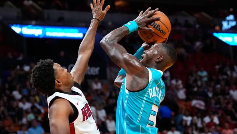 Oct 10, 2023; Miami, Florida, USA; Charlotte Hornets guard Terry Rozier (3) shoots over Miami Heat guard Kyle Lowry (7) during the first quarter at Kaseya Center. Mandatory Credit: Rich Storry-USA TODAY Sports