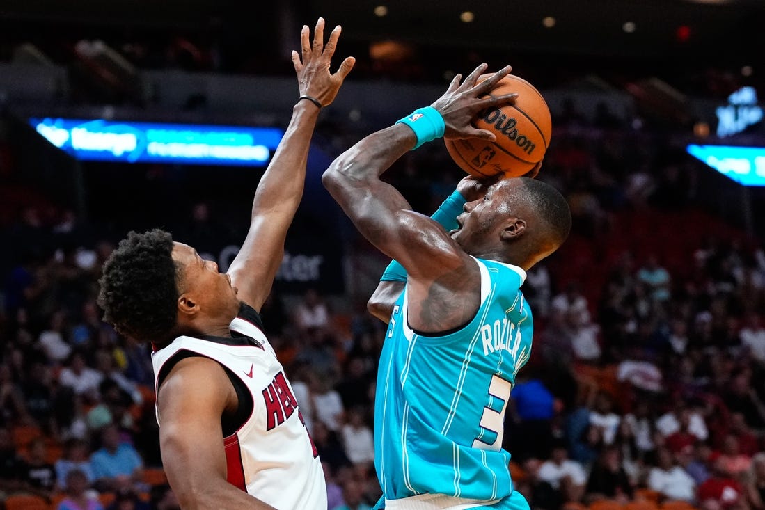 Oct 10, 2023; Miami, Florida, USA; Charlotte Hornets guard Terry Rozier (3) shoots over Miami Heat guard Kyle Lowry (7) during the first quarter at Kaseya Center. Mandatory Credit: Rich Storry-USA TODAY Sports