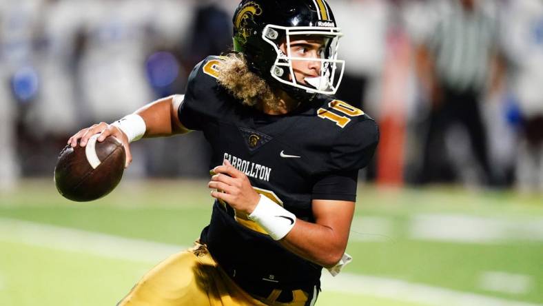 Oct 20, 2023; Carrollton, GA, USA; Carrollton Trojans quarterback Julian Lewis (10) scrambles out of the pocket against the Westlake Lions during the first half at Grisham Stadium. The 15-year-old Carrollton High student has already committed to playing for the University of Southern California Trojans and has been considered one of the top high school quarterback prospects. Mandatory Credit: John David Mercer-USA TODAY Sports