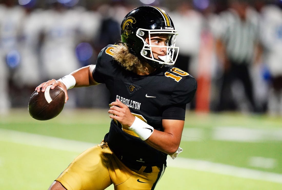 Oct 20, 2023; Carrollton, GA, USA; Carrollton Trojans quarterback Julian Lewis (10) scrambles out of the pocket against the Westlake Lions during the first half at Grisham Stadium. The 15-year-old Carrollton High student has already committed to playing for the University of Southern California Trojans and has been considered one of the top high school quarterback prospects. Mandatory Credit: John David Mercer-USA TODAY Sports