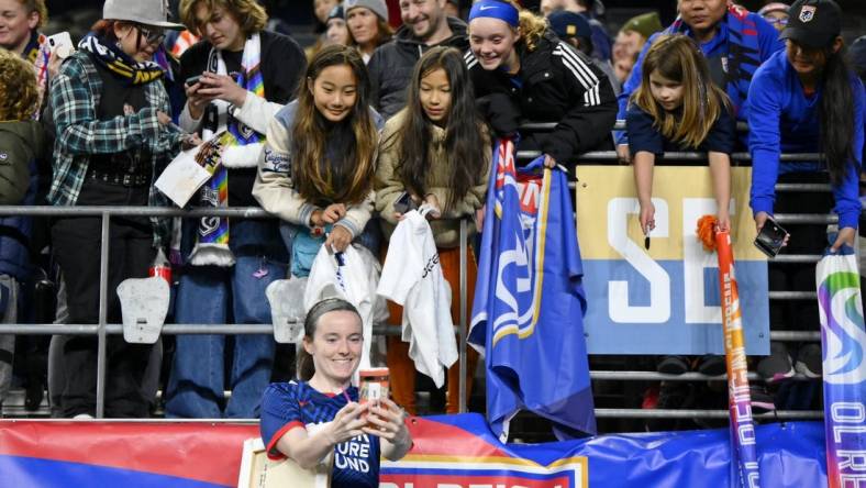 Oct 20, 2023; Seattle, Washington, USA; OL Reign midfielder Rose Lavelle (16) takes a selfie with fans after their win against Angel City FC at Lumen Field. Mandatory Credit: Steven Bisig-USA TODAY Sports