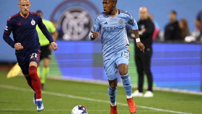 Oct 21, 2023; New York, NY, New York, NY, USA; New York City FC midfielder Andres Perea (15) dribbles against Chicago Fire midfielder Fabian Herbers (21) during the second half at Citi Field. Mandatory Credit: Vincent Carchietta-USA TODAY Sports