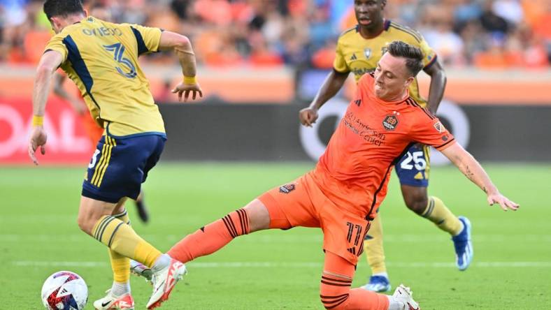 Oct 29, 2023; Houston, TX, USA; Houston Dynamo forward Corey Baird (11) kicks the bal from Real Salt Lake defender Bryan Oviedo (3) in the first half for game one in a round one match of the 2023 MLS Cup Playoffs at Shell Energy Stadium. Mandatory Credit: Maria Lysaker-USA TODAY Sports